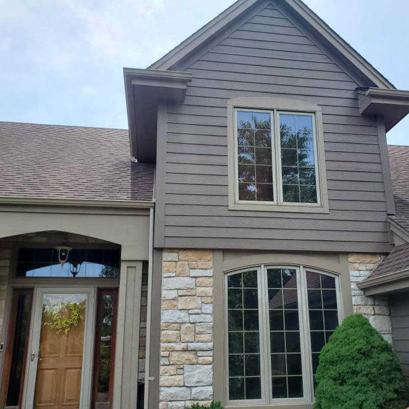 Siding and stone exterior by Precision Home Exteriors